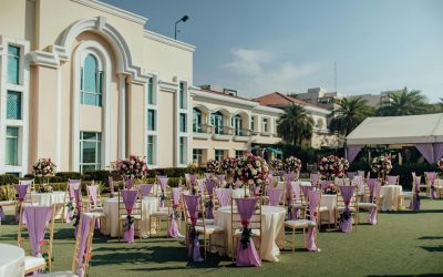 Luxurious outdoor wedding reception with floral arrangements and elegant decor.